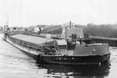 A heavily laden motor barge