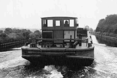 An unladen motor barge under way.