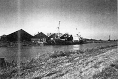 A  vessel berthed in the Dutch River.