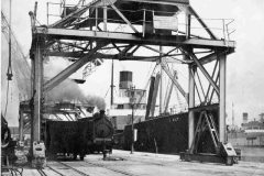 SS Alt through the legs of one of the port\'s rail-mounted travelling cranes.