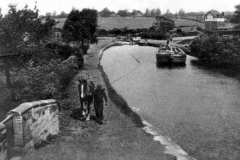 An empty dumb barge being towed upstream along the Barnsley Canal at Heath.