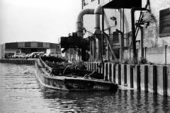 Barges Mossdale and Cordale H moored alongside a very large industrial unit.