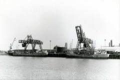 Two small diesel coasters at a quayside.