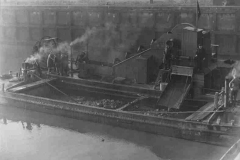 A dredger and lighter at work.